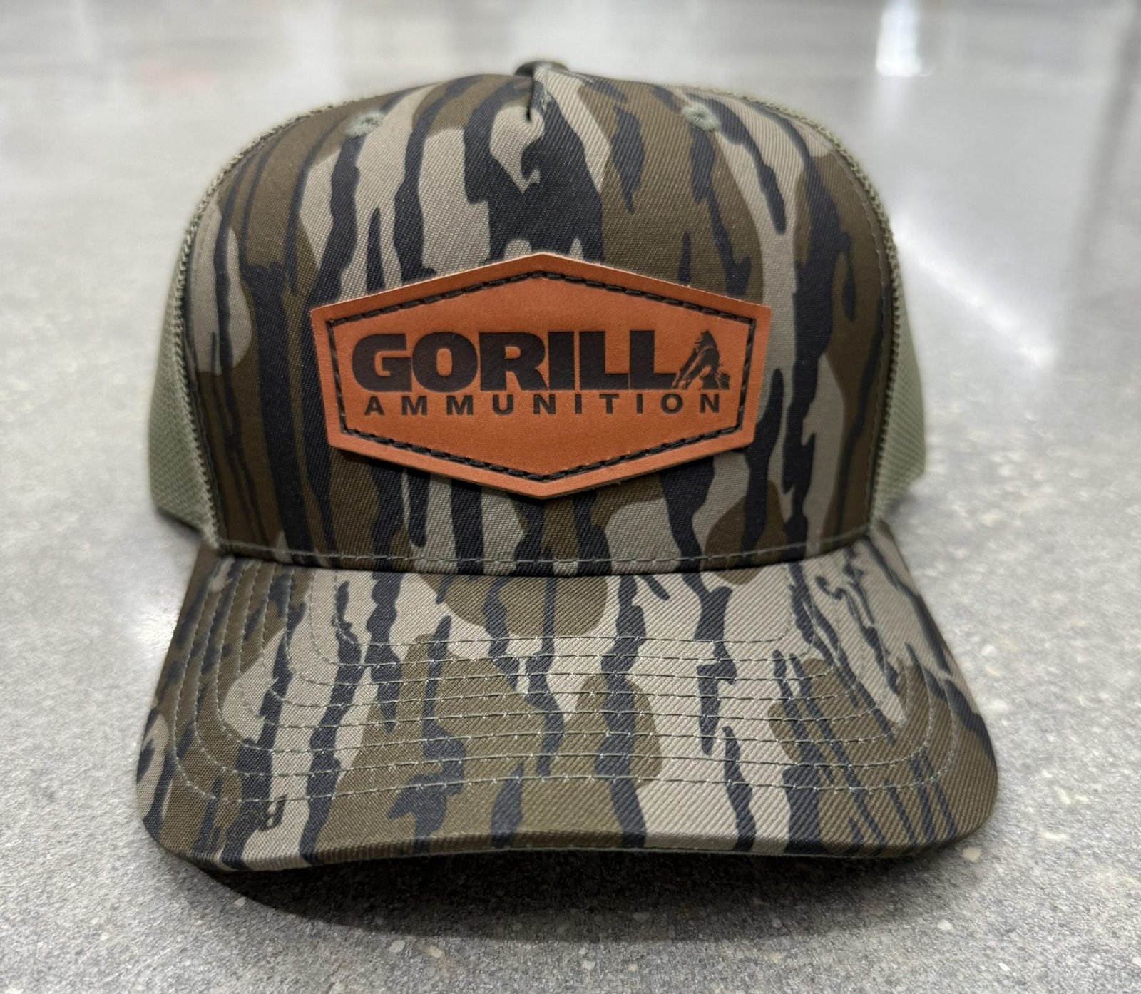 Leather Patch Trucker Hat - Mossy Oak Bottomland Camo